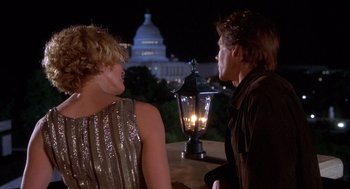 Movie still from “Hollow Man” (2000), directed by Paul Verhoeven – Two people are sitting at a table with a lit candle; Medium shot, Over the shoulder angle