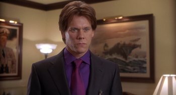 Movie still from “Hollow Man” (2000), directed by Paul Verhoeven – A person wearing a suit and tie; Close Up shot, Over the shoulder angle