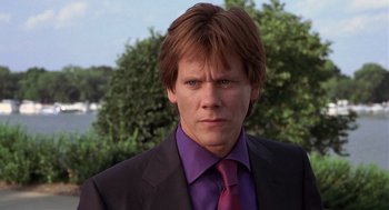 Movie still from “Hollow Man” (2000), directed by Paul Verhoeven – A person wearing a suit and tie; Close Up shot, Low angle