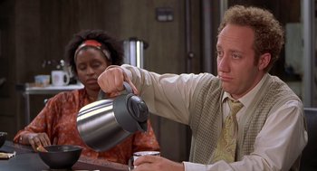 Movie still from “Hollow Man” (2000), directed by Paul Verhoeven – A man is pouring something into a tea pot; Medium shot, High angle