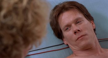 Movie still from “Hollow Man” (2000), directed by Paul Verhoeven – A person looking at a mirror; Close Up shot, Over the shoulder angle