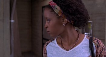 Movie still from “Hollow Man” (2000), directed by Paul Verhoeven – A young woman with a headband looking to the side; Close Up shot, Over the shoulder angle