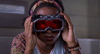 Movie still from “Hollow Man” (2000), directed by Paul Verhoeven – A woman wearing a pair of red goggles; Close Up shot, Low angle