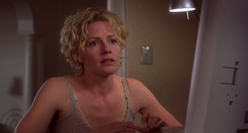 Movie still from “Hollow Man” (2000), directed by Paul Verhoeven – A woman sitting in front of a bathroom mirror; Close Up shot, Over the shoulder angle