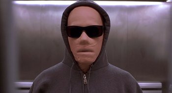 Movie still from “Hollow Man” (2000), directed by Paul Verhoeven – A man wearing sunglasses and a hooded sweatshirt; Close Up shot, Low angle