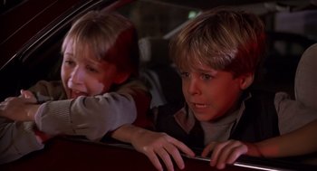 Movie still from “Hollow Man” (2000), directed by Paul Verhoeven – A young boy sitting in the passenger seat of a car looking out of the window; Close Up shot, High angle