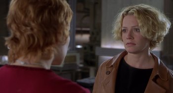 Movie still from “Hollow Man” (2000), directed by Paul Verhoeven – A woman looking at her reflection in a mirror; Close Up shot, Over the shoulder angle