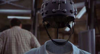 Movie still from “Hollow Man” (2000), directed by Paul Verhoeven – A helmet on a mannequin head; Close Up shot, Over the shoulder angle