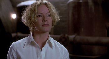 Movie still from “Hollow Man” (2000), directed by Paul Verhoeven – A woman with blonde hair wearing a white shirt; Close Up shot, Low angle