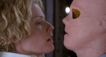 Movie still from “Hollow Man” (2000), directed by Paul Verhoeven – A woman's face and a mask; Close Up shot, Over the shoulder angle