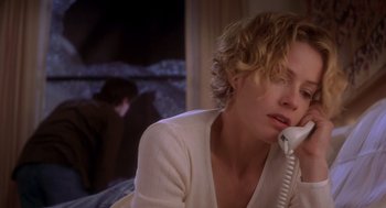 Movie still from “Hollow Man” (2000), directed by Paul Verhoeven – A woman sitting on a bed talking on the phone; Close Up shot, Low angle
