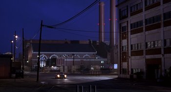 Movie still from “Hollow Man” (2000), directed by Paul Verhoeven – A car is parked on the side of the road at night; Extreme Wide shot, Low angle