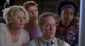 Movie still from “Hollow Man” (2000), directed by Paul Verhoeven – A group of people standing next to each other in a room; Close Up shot, Low angle