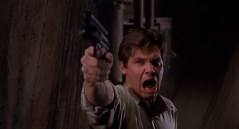 Movie still from “Hollow Man” (2000), directed by Paul Verhoeven – A man holding a gun in his hand and screaming; Close Up shot, Low angle