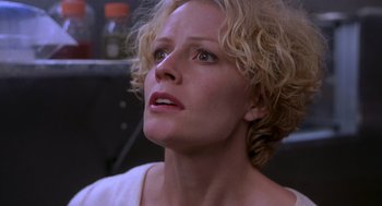 Movie still from “Hollow Man” (2000), directed by Paul Verhoeven – A person with curly blonde hair; Close Up shot, Low angle