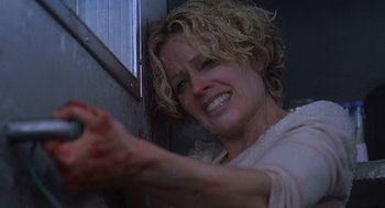 Movie still from “Hollow Man” (2000), directed by Paul Verhoeven – A person holding something in their hand; Close Up shot, Low angle