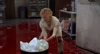 Movie still from “Hollow Man” (2000), directed by Paul Verhoeven – A woman in a white shirt is in a kitchen; Medium shot, High angle