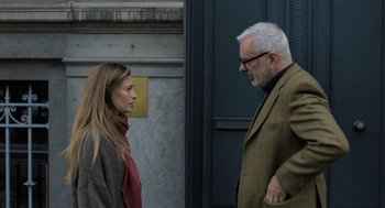 Movie still from “Holy Lands” (2017), directed by Amanda Sthers – A man and a woman standing next to each other; Medium shot, Over the shoulder angle