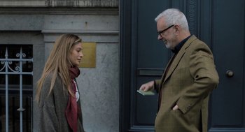 Movie still from “Holy Lands” (2017), directed by Amanda Sthers – An older man and a younger woman standing next to each other; Medium shot, Over the shoulder angle