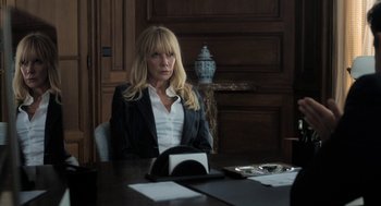 Movie still from “Holy Lands” (2017), directed by Amanda Sthers – A woman sitting at a table in front of a laptop; Medium shot, Over the shoulder angle