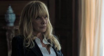 Movie still from “Holy Lands” (2017), directed by Amanda Sthers – A woman with blonde hair wearing a white shirt and a jacket; Close Up shot, Low angle