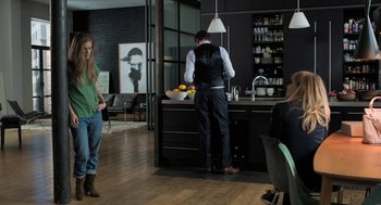 Movie still from “Holy Lands” (2017), directed by Amanda Sthers – A man and a woman standing in a kitchen; Wide shot, Over the shoulder angle