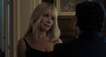 Movie still from “Holy Lands” (2017), directed by Amanda Sthers – A woman in a black dress talking to a man in a black suit; Close Up shot, Over the shoulder angle