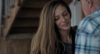 Movie still from “Holy Lands” (2017), directed by Amanda Sthers – A beautiful woman with long brown hair looking down at her face; Close Up shot, Over the shoulder angle