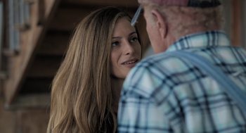 Movie still from “Holy Lands” (2017), directed by Amanda Sthers – A young woman and an older man are talking to each other; Close Up shot, Over the shoulder angle