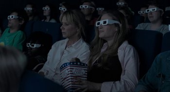 Movie still from “Holy Lands” (2017), directed by Amanda Sthers – Two women are watching a movie in a theater; Medium shot, High angle