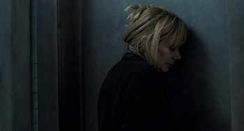 Movie still from “Holy Lands” (2017), directed by Amanda Sthers – A woman standing in front of a wall with her head turned to the side; Close Up shot, Overhead angle