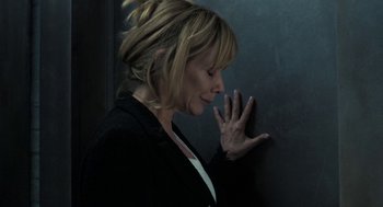 Movie still from “Holy Lands” (2017), directed by Amanda Sthers – A woman leaning against a wall with her hand touching her face; Close Up shot, High angle