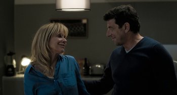 Movie still from “Holy Lands” (2017), directed by Amanda Sthers – A man and a woman smiling at each other; Medium shot, Over the shoulder angle