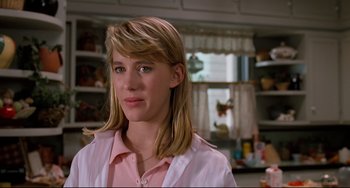 Movie still from “Honey, I Shrunk the Kids” (1989), directed by Joe Johnston – A woman with long blonde hair wearing a pink shirt; Close Up shot, Low angle