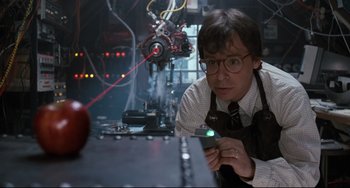 Movie still from “Honey, I Shrunk the Kids” (1989), directed by Joe Johnston – A man holding a cell phone in his hands; Medium shot, Low angle