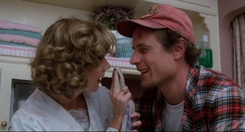 Movie still from “Honey, I Shrunk the Kids” (1989), directed by Joe Johnston – A man and a woman smiling at each other while looking at each other; Close Up shot, Over the shoulder angle