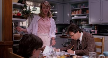 Movie still from “Honey, I Shrunk the Kids” (1989), directed by Joe Johnston – A group of people sitting around a table; Medium shot, Over the shoulder angle