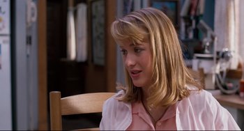 Movie still from “Honey, I Shrunk the Kids” (1989), directed by Joe Johnston – A young woman sitting on a chair in front of a window; Close Up shot, Over the shoulder angle