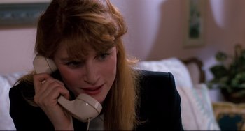 Movie still from “Honey, I Shrunk the Kids” (1989), directed by Joe Johnston – A woman talking on a phone while sitting on a bed; Close Up shot, High angle