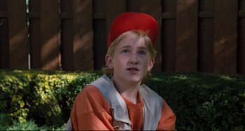 Movie still from “Honey, I Shrunk the Kids” (1989), directed by Joe Johnston – A young boy wearing an orange hat and orange shirt; Close Up shot, Low angle