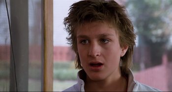 Movie still from “Honey, I Shrunk the Kids” (1989), directed by Joe Johnston – A person wearing a white shirt; Close Up shot, Low angle