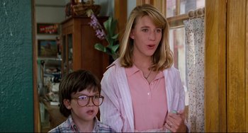 Movie still from “Honey, I Shrunk the Kids” (1989), directed by Joe Johnston – A woman and a young boy are standing next to each other; Medium shot, Low angle