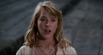Movie still from “Honey, I Shrunk the Kids” (1989), directed by Joe Johnston – A young woman with long blonde hair wearing a pink shirt; Close Up shot, Over the shoulder angle