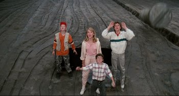 Movie still from “Honey, I Shrunk the Kids” (1989), directed by Joe Johnston – A group of kids standing next to each other on the street; Wide shot, Overhead angle