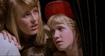 Movie still from “Honey, I Shrunk the Kids” (1989), directed by Joe Johnston – Two young women and a young boy looking at the camera; Close Up shot, Low angle