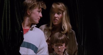 Movie still from “Honey, I Shrunk the Kids” (1989), directed by Joe Johnston – A group of people standing next to each other in a room; Close Up shot, Low angle