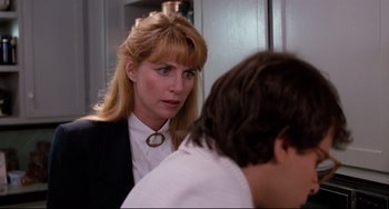 Movie still from “Honey, I Shrunk the Kids” (1989), directed by Joe Johnston – A woman in a white shirt and black jacket talking to a man in a white shirt and black jacket; Close Up shot, Over the shoulder angle