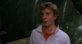Movie still from “Honey, I Shrunk the Kids” (1989), directed by Joe Johnston – A young man in a white jacket looking at the camera; Close Up shot, Low angle