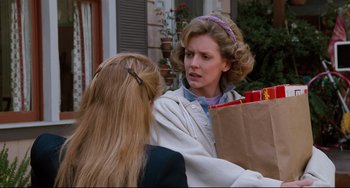Movie still from “Honey, I Shrunk the Kids” (1989), directed by Joe Johnston – A woman holding a brown bag talking to another woman; Medium shot, Over the shoulder angle