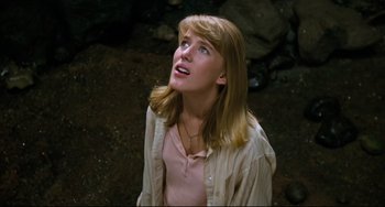 Movie still from “Honey, I Shrunk the Kids” (1989), directed by Joe Johnston – A woman with blonde hair and a pink shirt looking up; Close Up shot, Low angle